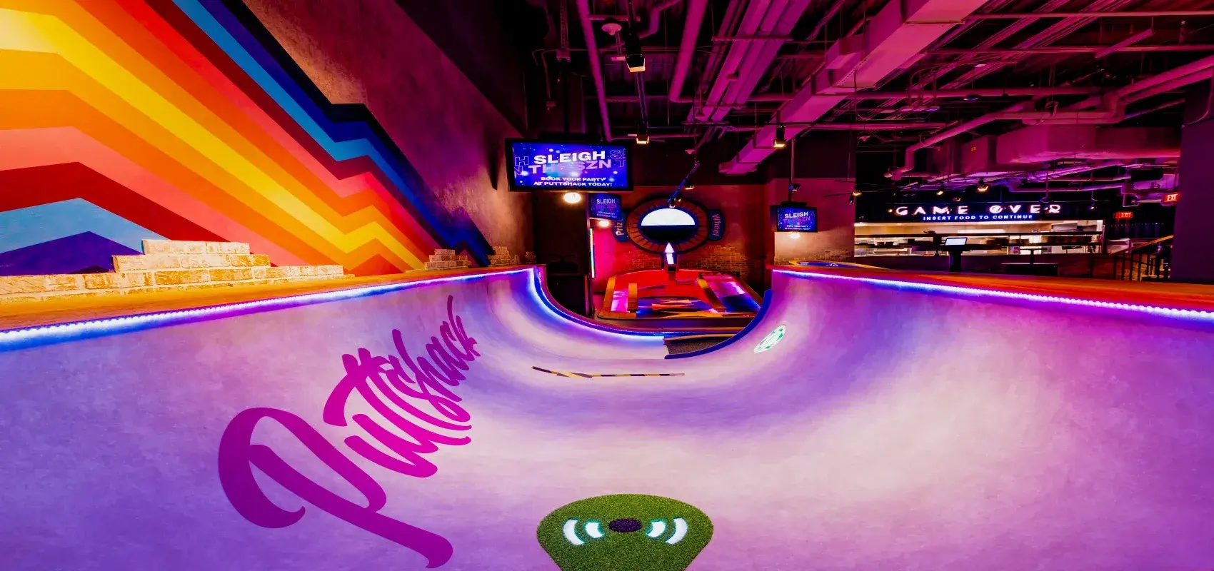 A close up of a half pipe mini golf course